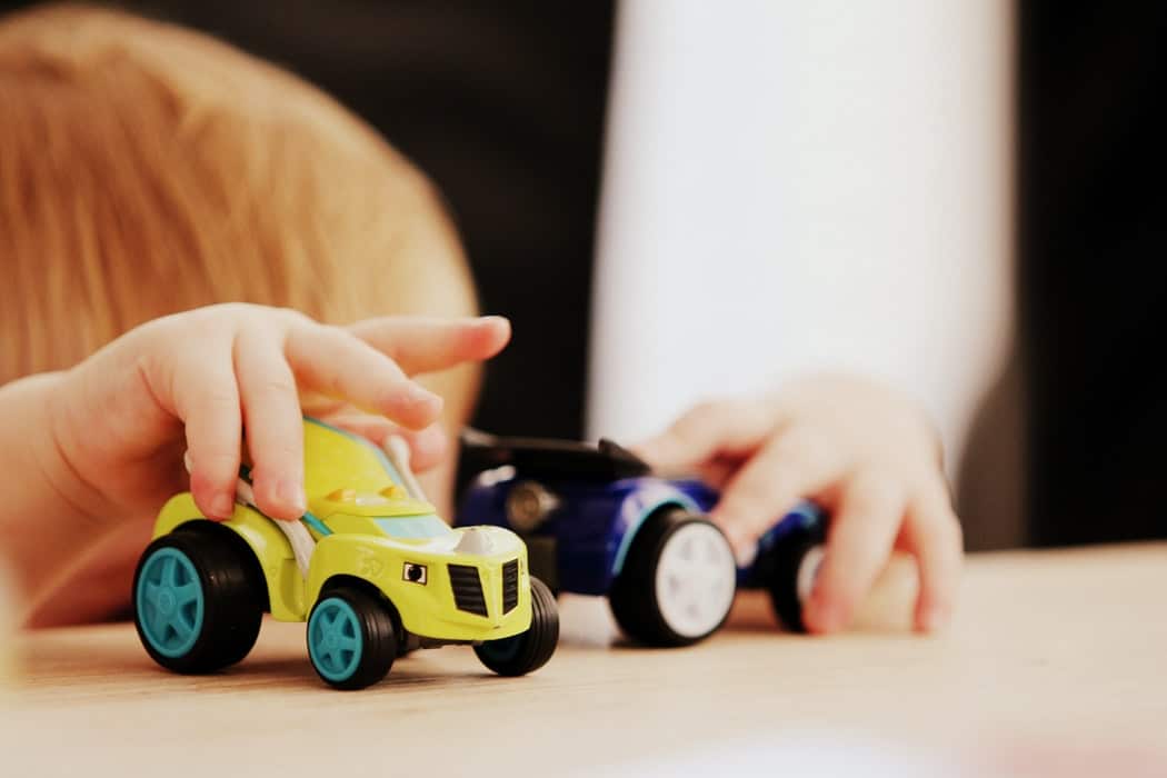 A child playing with toy cars