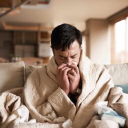 Man sick at home with the common cold.