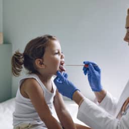 Young girl having her tonsils checked