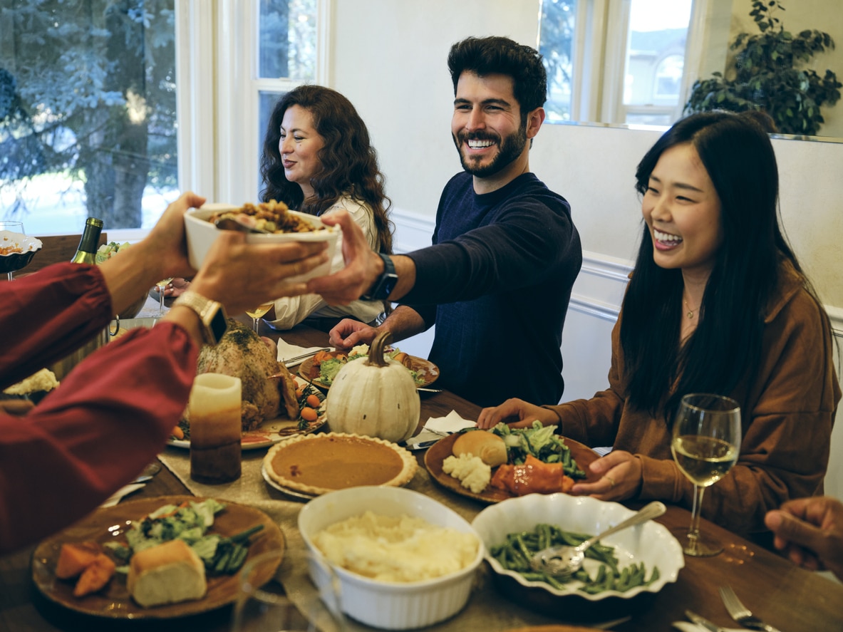 Smiling group of friends celebrating Thanksgiving together.