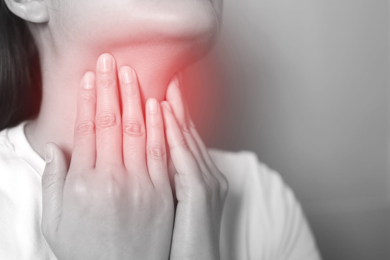 Woman with a red sore throat.