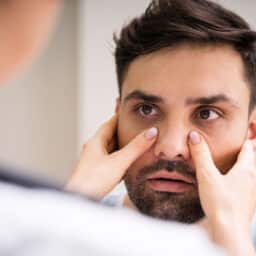 Doctor examines man's sinus pressure